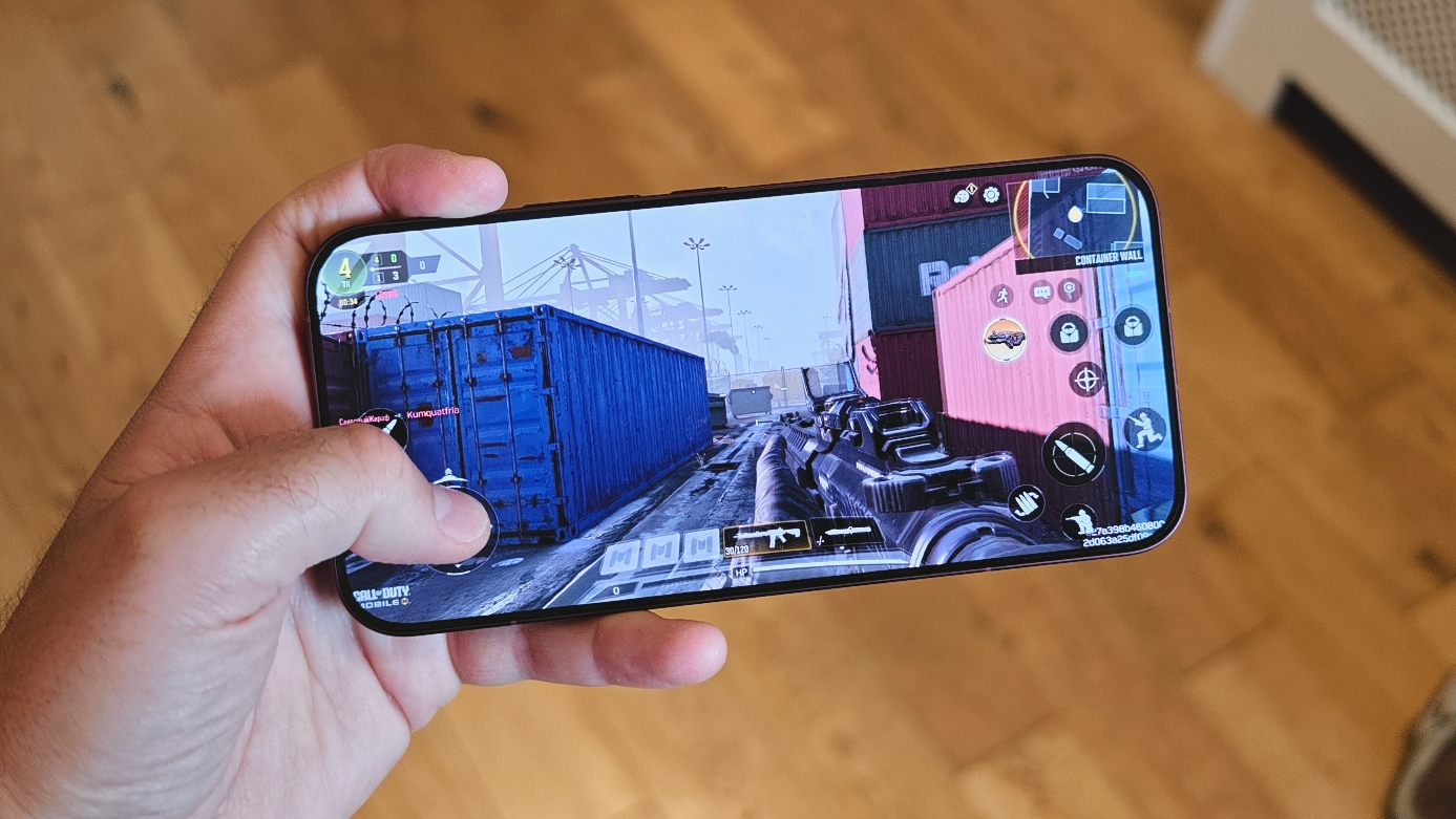 The Poco F9 Ultra being held in the hand and resting on a table