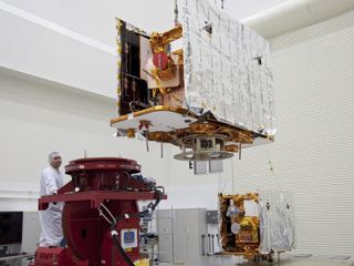Technicians lift one of two spacecraft for NASA's Gravity Recovery and Interior Laboratory, or GRAIL, to a test stand in the Astrotech payload processing facility in Titusville, FL, on May 21, 2011.