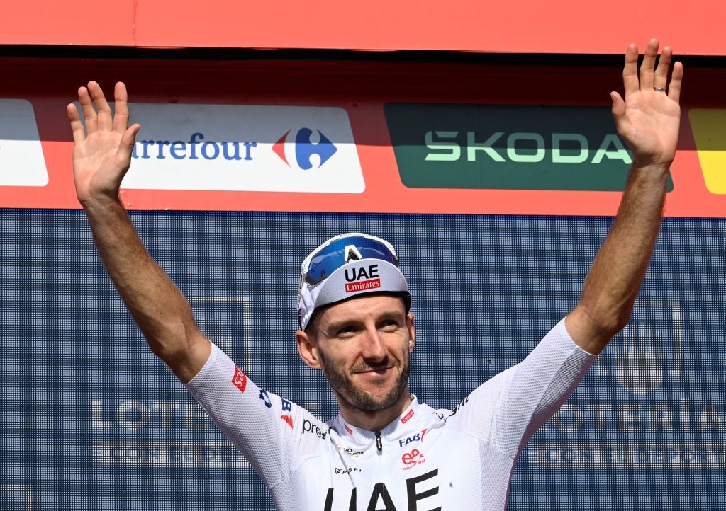 Climber ranking leader Team UAE&#039;s Adam Yates celebrates on the podium after the stage 10 of La Vuelta a Espana cycling tour, a 160 km race between Ponteareas and Baiona, in Baiona on August 27, 2024. (Photo by MIGUEL RIOPA / AFP)