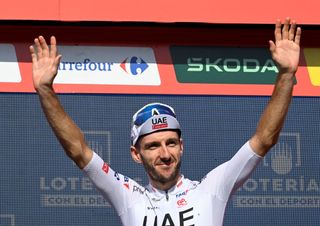 Climber ranking leader Team UAE's Adam Yates celebrates on the podium after the stage 10 of La Vuelta a Espana cycling tour, a 160 km race between Ponteareas and Baiona, in Baiona on August 27, 2024. (Photo by MIGUEL RIOPA / AFP)