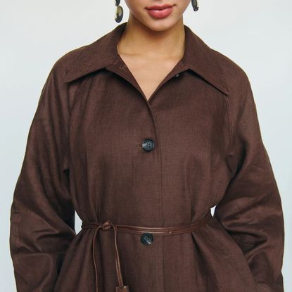 model wearing reformation trench coat