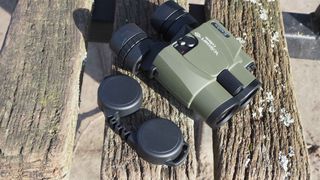 Kenko VC Smart Cellarto 10x30 WP binoculars on a wooden bench outside in front of a lake