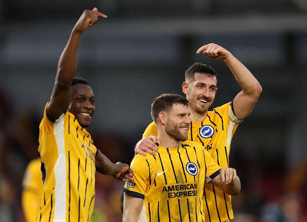Lewis Dunk (R) and Danny Welbeck of Brighton & Hove Albion (L) gather around teammate James Milner to celebrate him breaking the Premier League appearance record following the team's victory in the Premier League match between Brentford and Brighton & Hove Albion at Gtech Community Stadium on February 21, 2026 in Brentford, England.