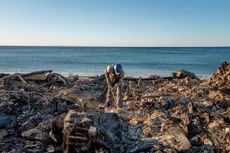 Man clearing debris from LA wildfires