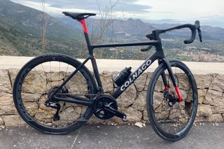 Colnago V4RS against a wall with a view out to mountains