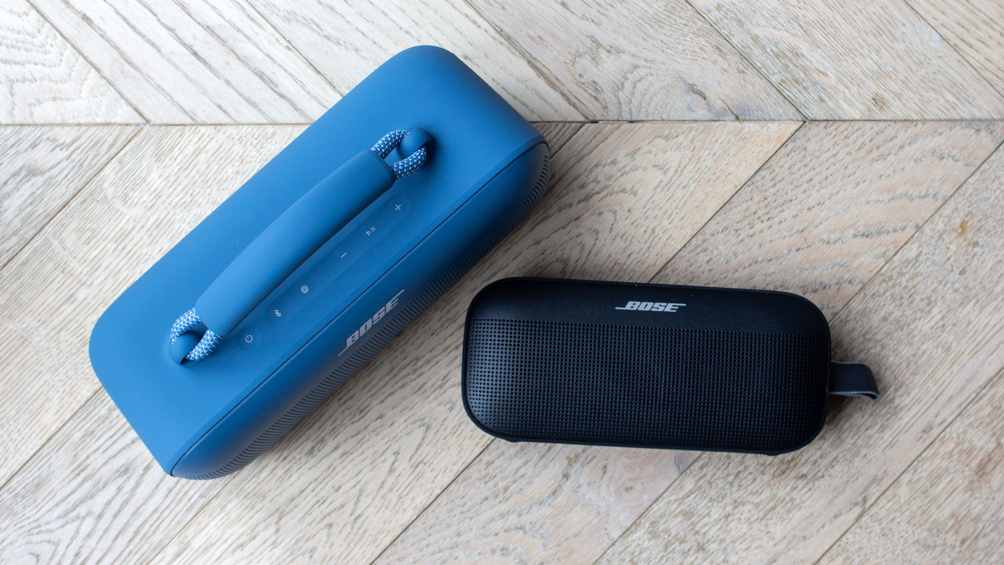A side-by-side view of a blue Bose Soundlink Max and a black Bose Soundlink Flex.