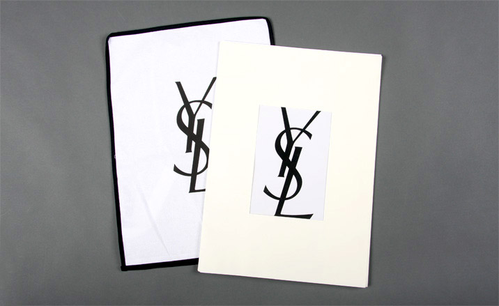 A large A3 sized booklet, the manifesto is cased in a cloth bag lined with black piping, sealed with a zip at the bottom.