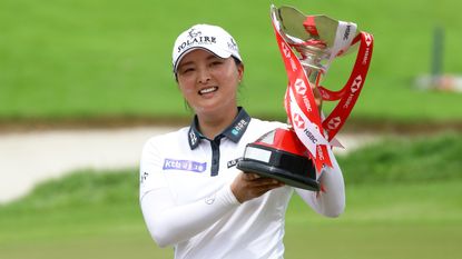 Jin Young Ko holds aloft the trophy after winning the 2022 HSBC Women's World Championship at Sentosa Golf Club