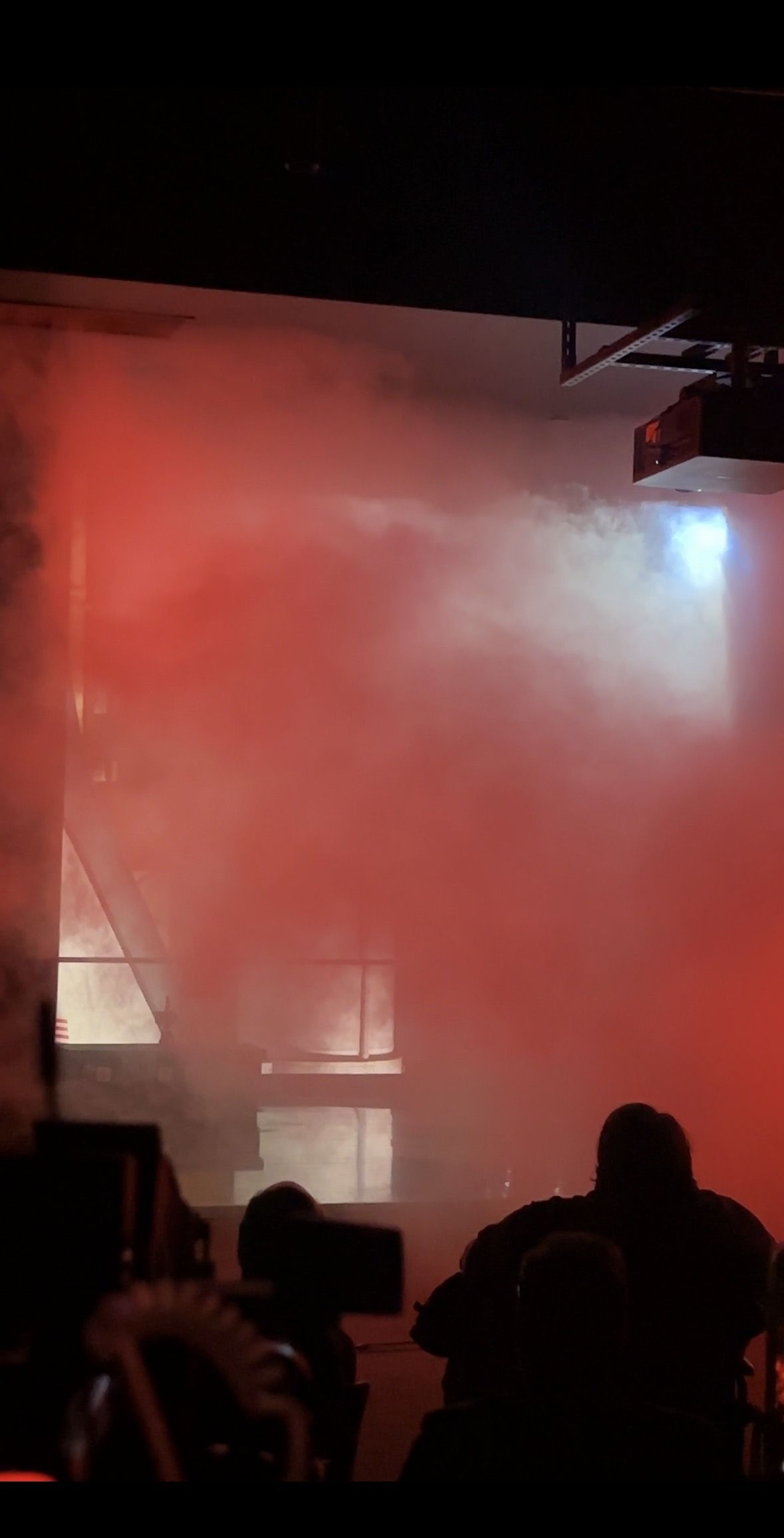 Red smoke thinly veils a shuttle behind it.