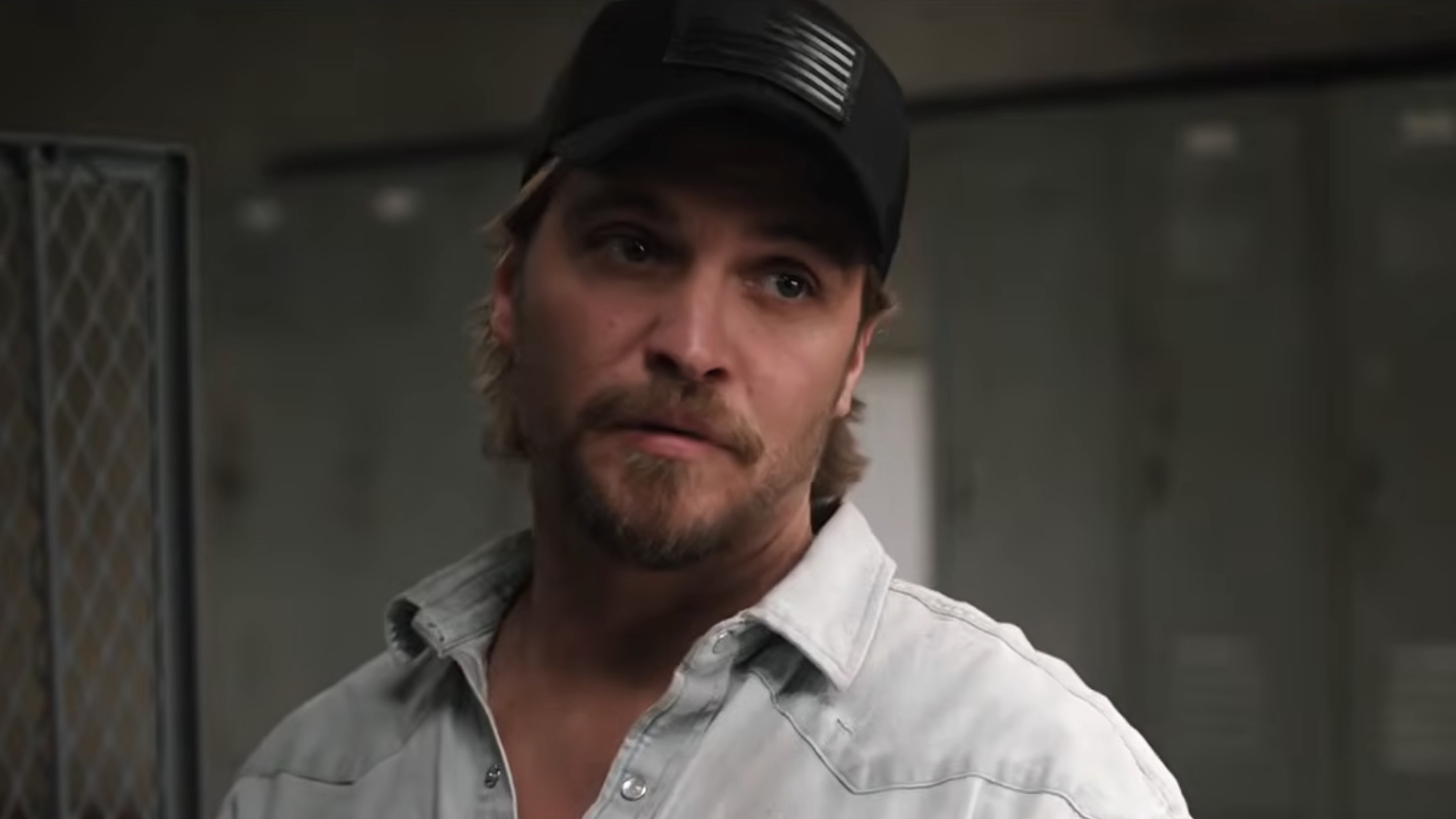 Kayce in black cap standing in locker room in Marshals Season 2