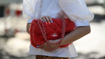 Sonia Lyson wearing a red Chanel bag and a colour manicure
