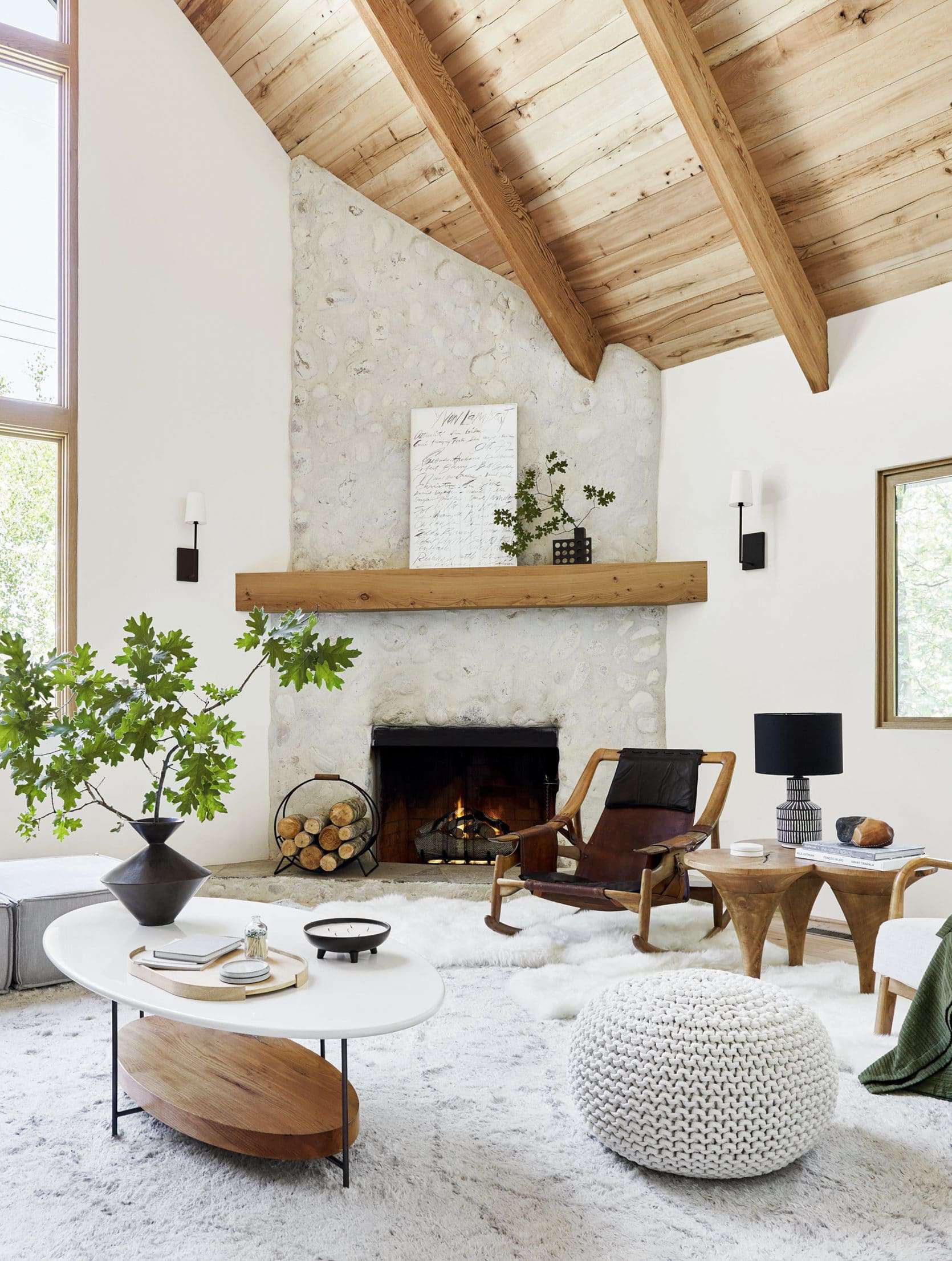 Modern rustic living room designed by Emily Henderson with corner fireplace