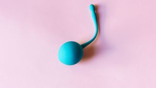 Blue sex toy on pink background