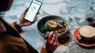 Chat GDP diet tips: A woman eating a salad using her phone