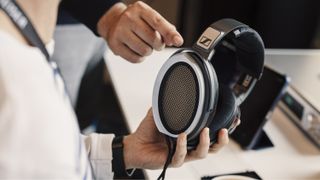 Sennheiser HE 1 wired headphones being held