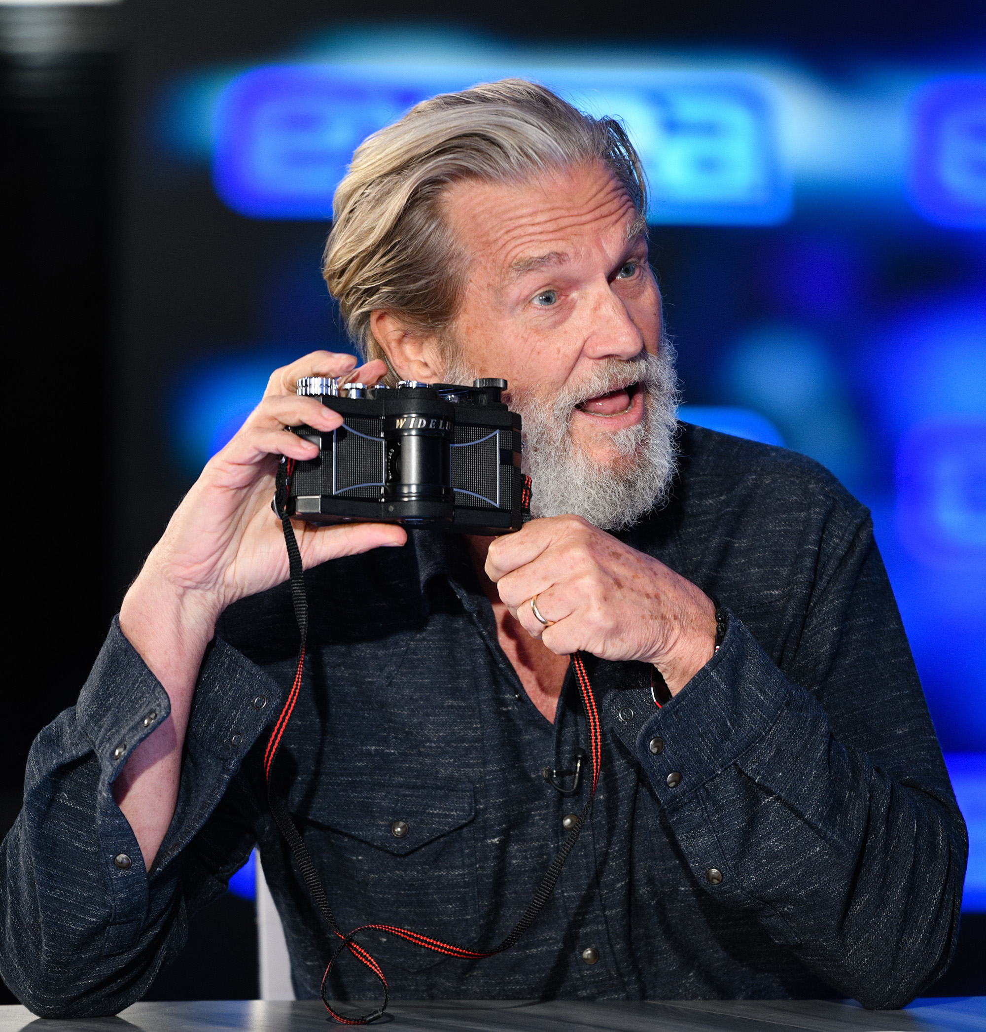 BURBANK, CALIFORNIA - DECEMBER 13: Jeff Bridges takes a picture with his Widelux camera at &quot;Extra&quot; at Burbank Studios on December 13, 2019 in Burbank, California.