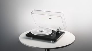 Pro-Ject Debut Reference 10 turntable sitting on a round table