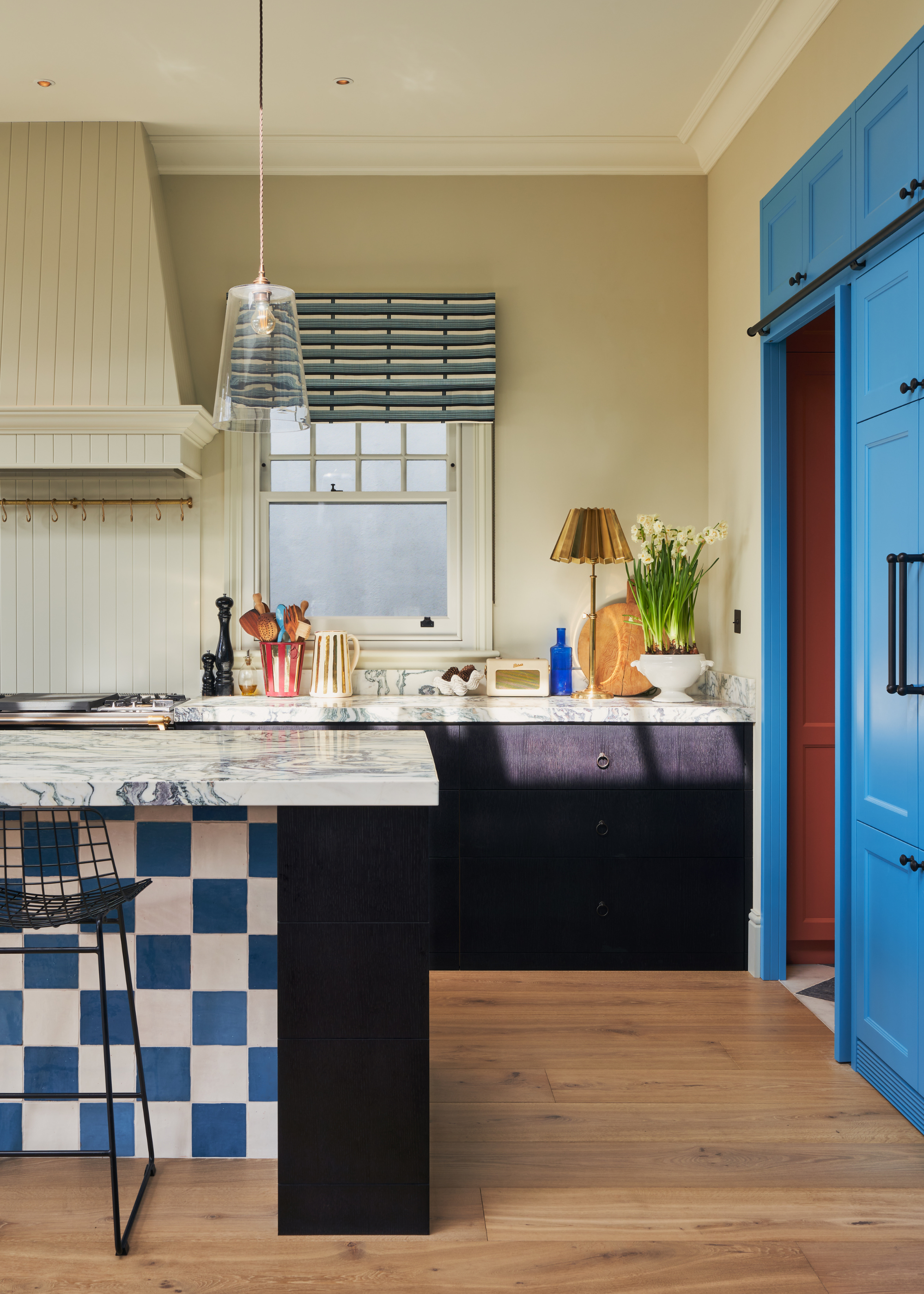 kitchen with blue cabinets and a checkered blue tiled island