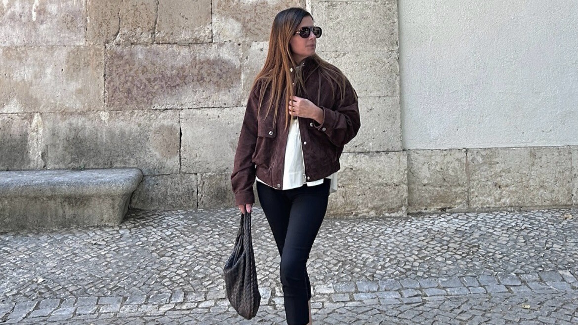 Woman wears capri pants and almond toe flats.