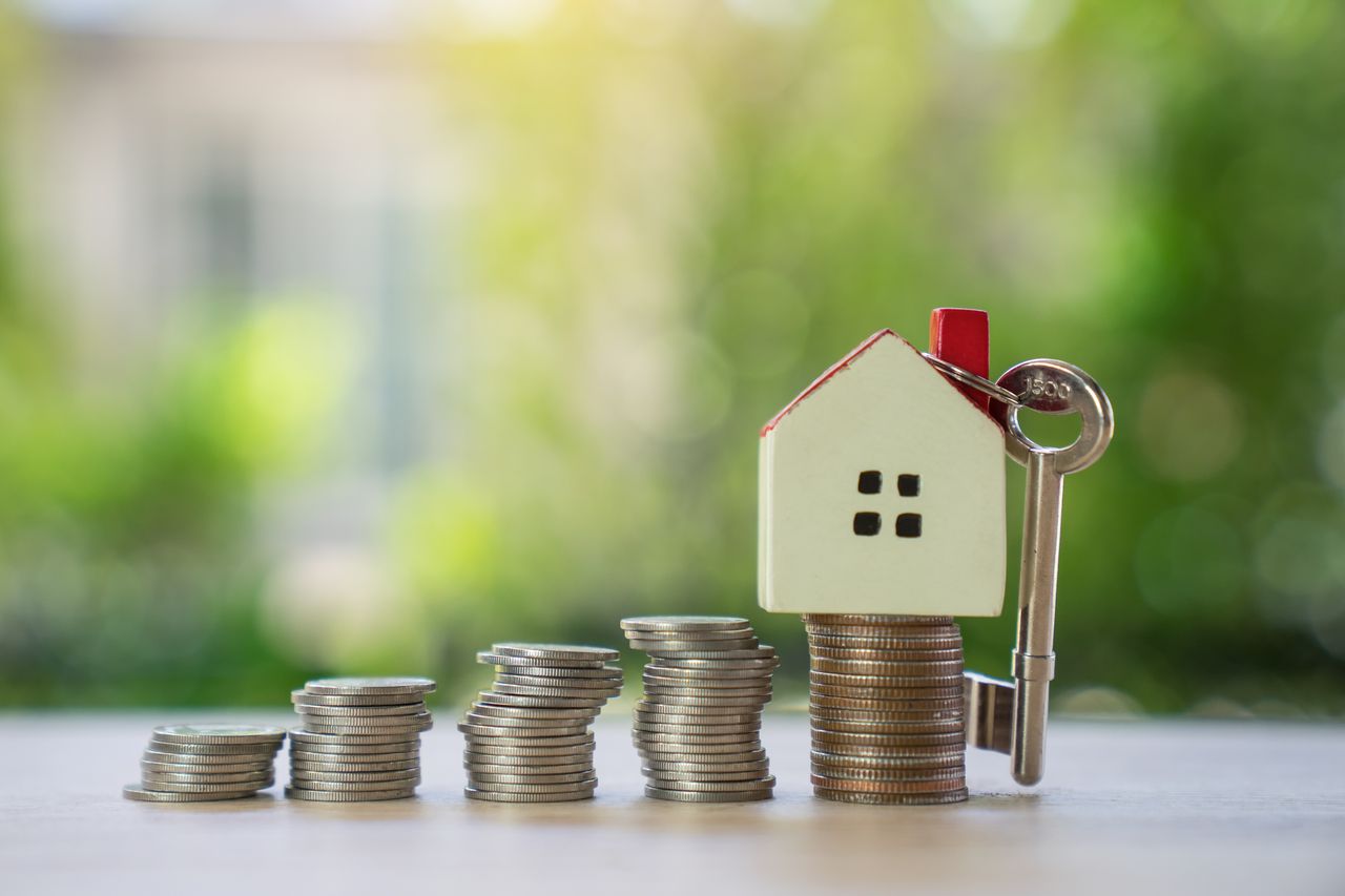 House model on pile of coins