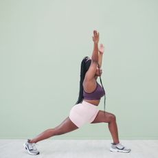 A woman doing a forward lunge