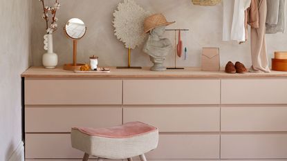 Ikea chest of drawers painted in pale pink and topped with wooden plank
