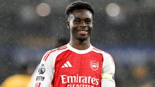 Bukayo Saka of Arsenal celebrates scoring his team's first goal during the Premier League match between Wolverhampton Wanderers and Arsenal at Molineux on February 18, 2026 in Wolverhampton, England.