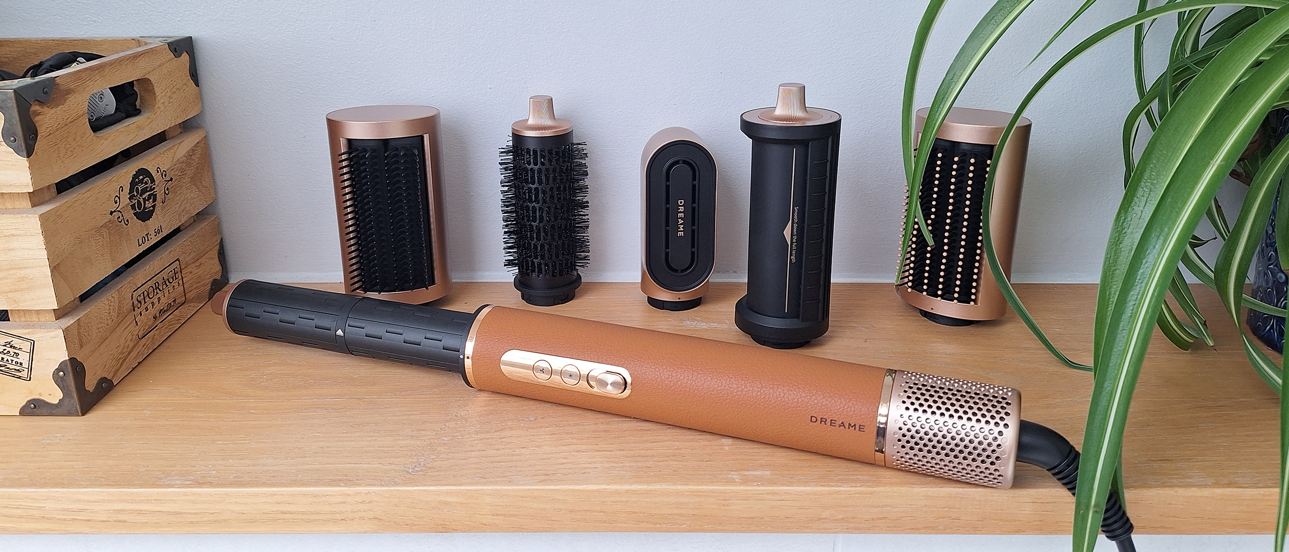 Dreame AirStyle Pro on shelf in reviewer&#039;s bathroom, with attachments lined up behind