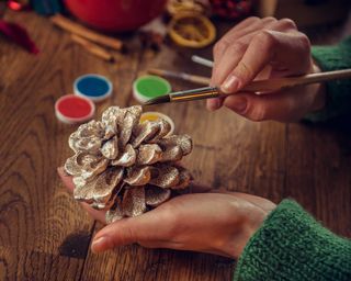 Hand painting pine cone with silver glitter