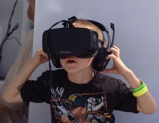 A young boy wears a VR headset