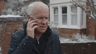 Charlie on the phone outside in the snow after discovering Duffy is missing