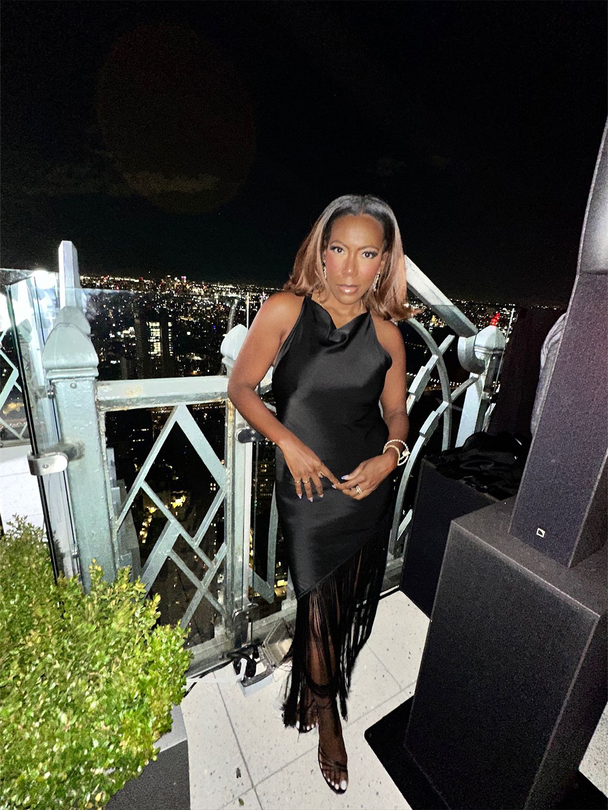 Tiffany Reid wearing a black silk top and skirt during fashion month.