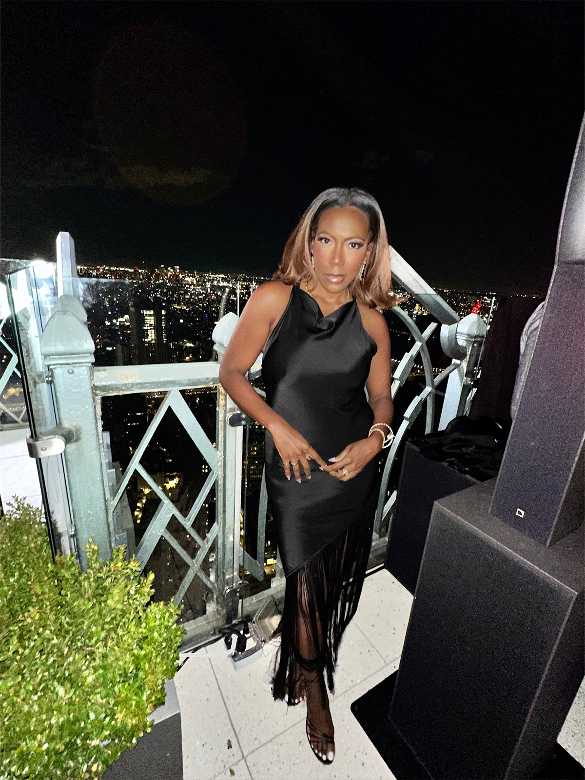 Tiffany Reid wearing a black silk top and skirt during fashion month.