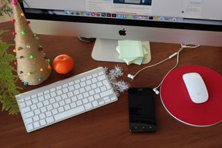 Desktop computer with red mousepad and Christmas decorations