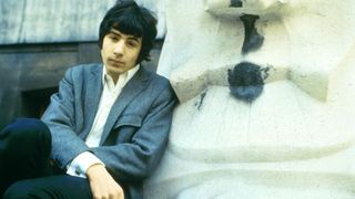 Cat Stevens leaning against a sculpture in the 1960s