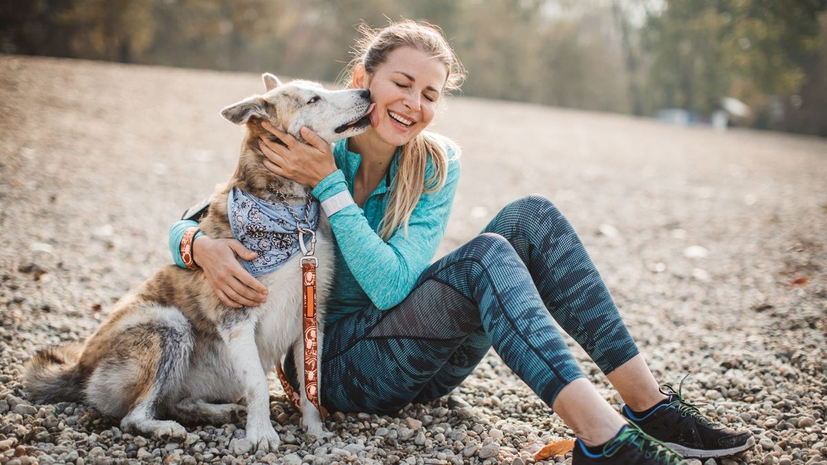 women sat with dog in park