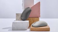 The ZenMouse MD202 seen in Moher Gray and Scandinavian White, surrounded by various slabs of slate and similar rocks.