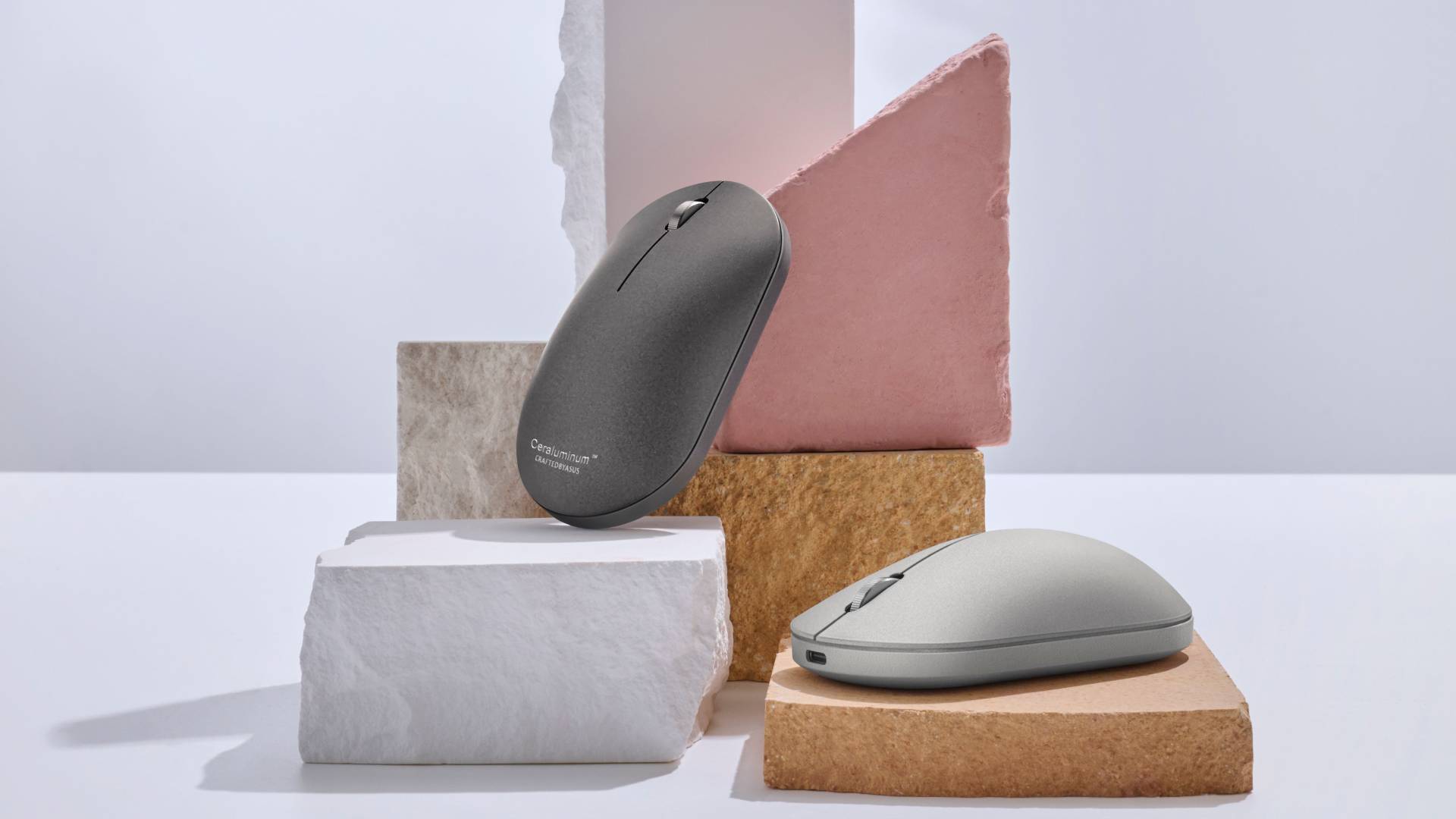 The ZenMouse MD202 seen in Moher Gray and Scandinavian White, surrounded by various slabs of slate and similar rocks.