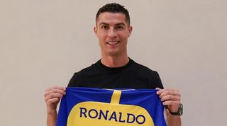 Cristiano Ronaldo holds an Al-Nassr shirt after agreeing a move to the Saudi Arabian club.
