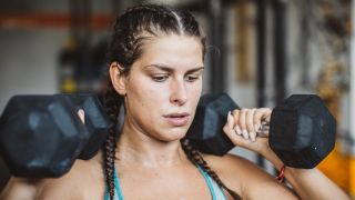 Woman holding dumbbells