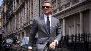 Daniel Craig wearing sunglasses as James Bond in No Time to Die as James Bond