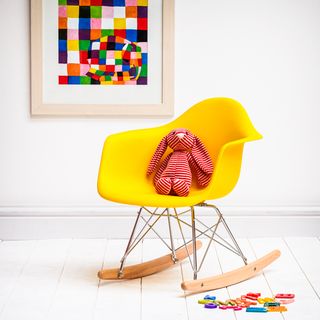 white room with yellow rocking chair and white flooring