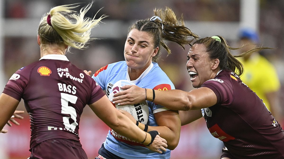  Blues player is tackled by two Maroons in the Women&#039;s State of Origin