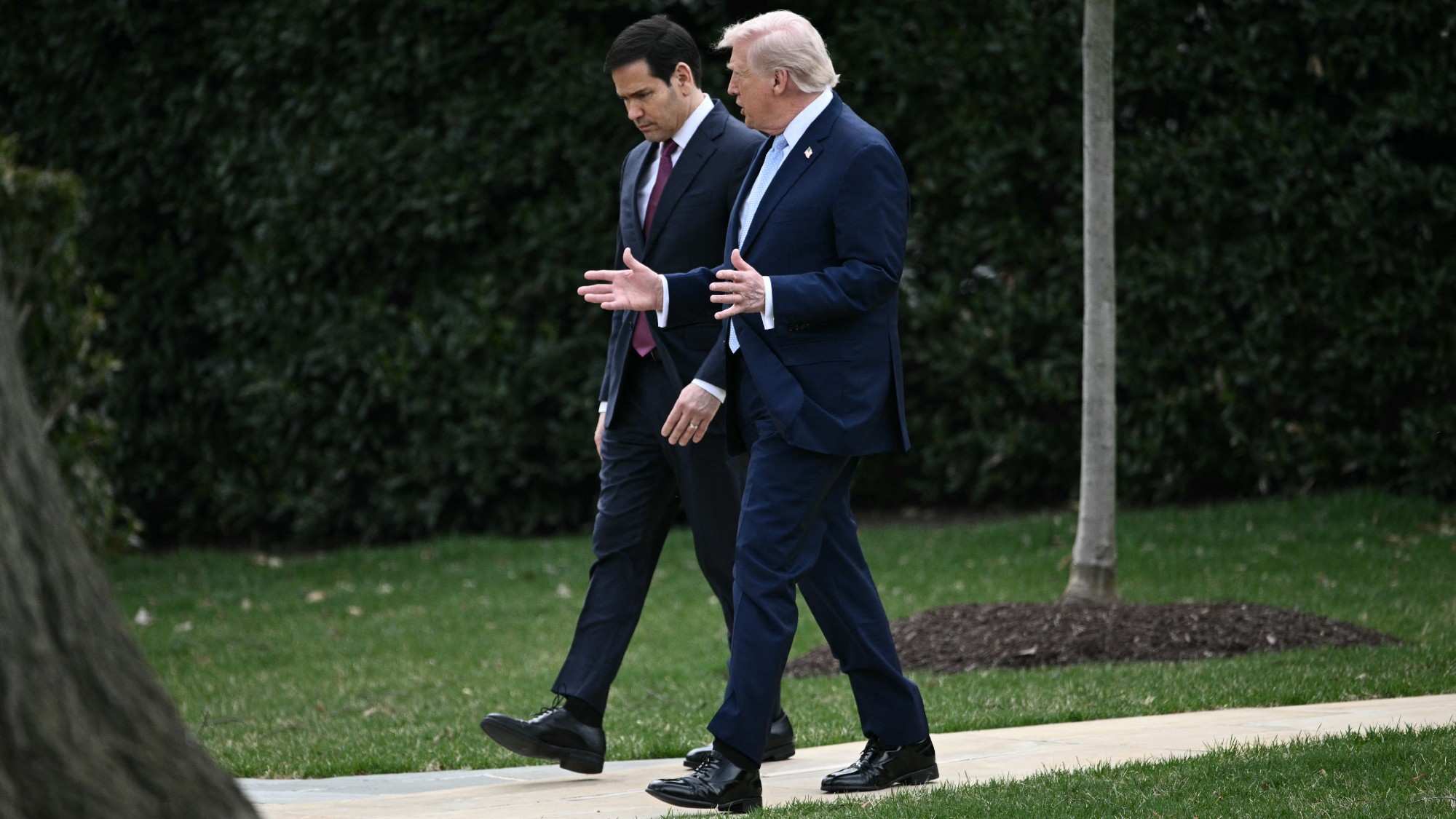 Marco Rubio and Donald Trump walk at the White House