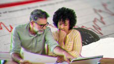 Couple discussing pension drawdown plans over a laptop with stock market graphics in background