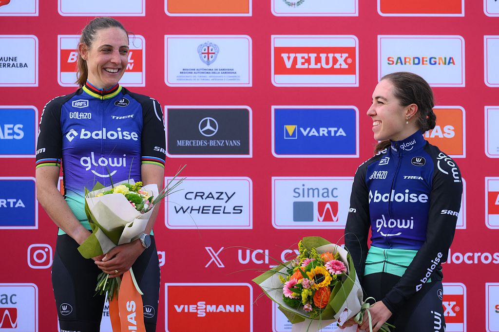 Dutch Lucinda Brand and Dutch Shirin van Anrooij pictured on the podium after the women's elite race of the Cyclocross World Cup, in Terralba, Sardinia, Italy, Sunday 07 December 2025, stage 3 (out of 12) in the World Cup of the 2026-2027 season. BELGA PHOTO DAVID PINTENS (Photo by DAVID PINTENS / BELGA MAG / Belga via AFP)