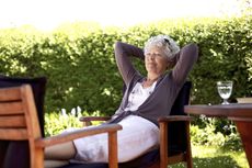 Person Relaxing On Patio Furniture
