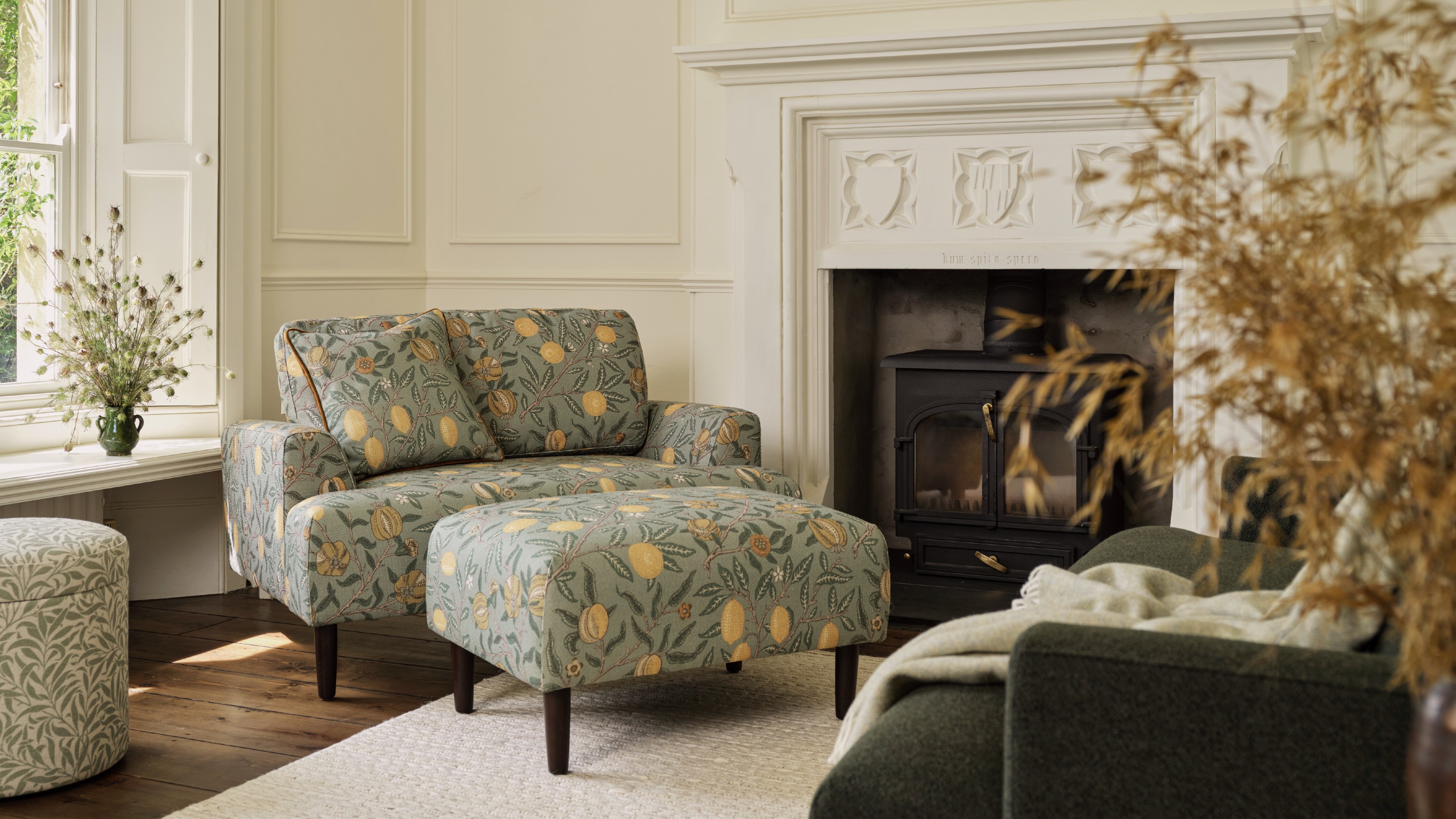 The Swyft Model 05 Loveseat in Morris & Co.'s Fruit print with a matching ottoman in a period living room
