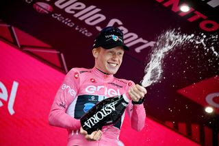 Andreas Leknessund celebrates on the Giro d'Italia podium with champagne