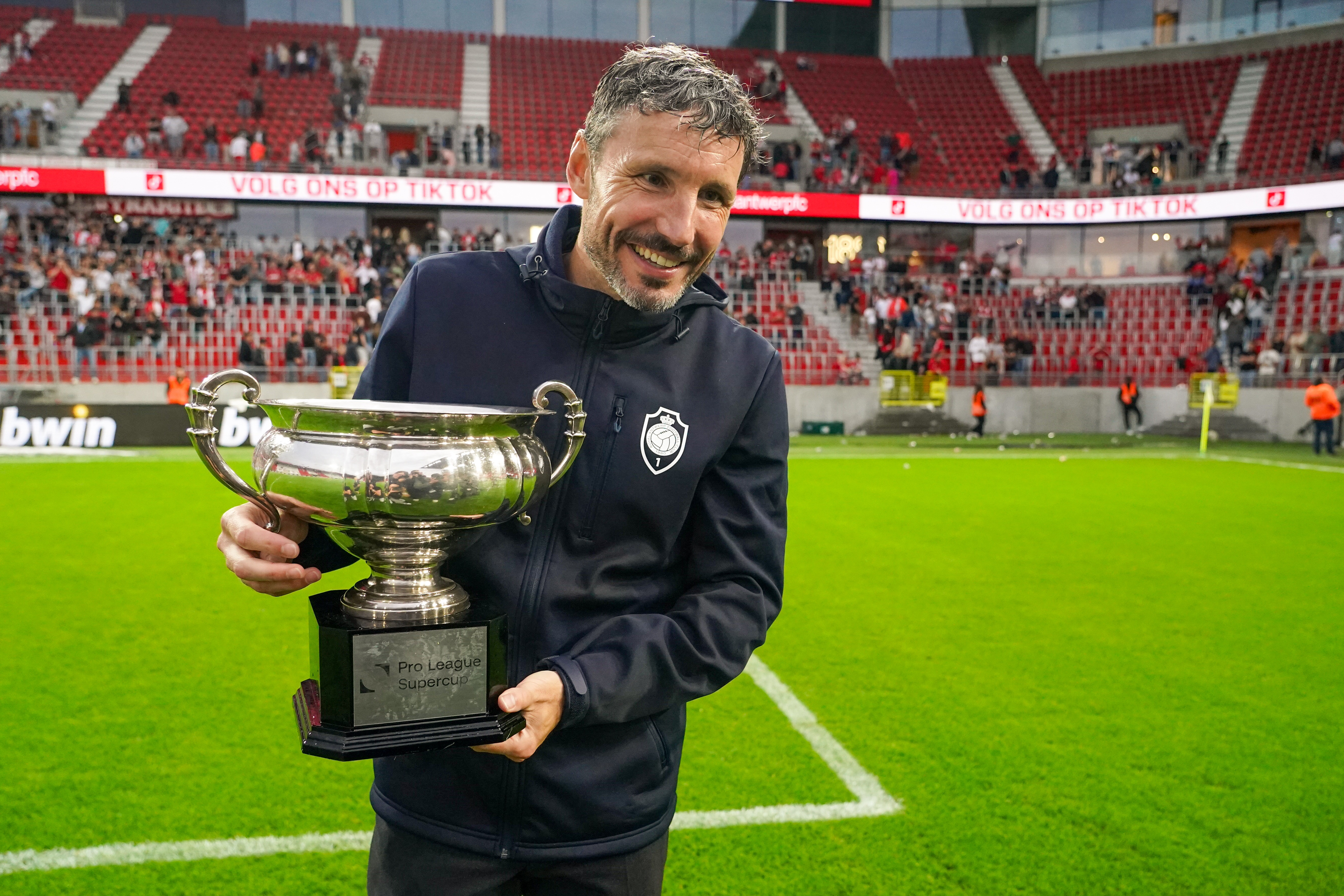 Royal Antwerp coach Mark van Bommel celebrates with the Belgian Super Cup after victory over Mechelen in July 2023.